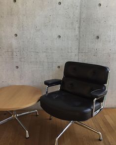 an office chair next to a wooden table