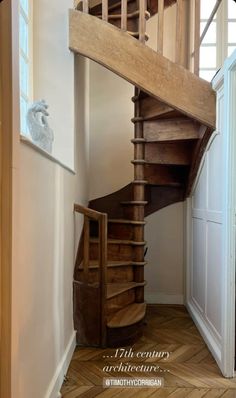 a wooden spiral staircase in an old house