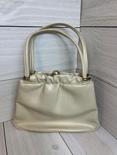 Simple but elegant beige retro handbag.  Biege leather.  The outside is in excellent condition as well as the inside and this is true beige color.  The inside is lined in a chocolate brown linen.  There is one larger inside part to the bag that snaps shut almost like a coin purse that is mounted inside the bag with open pockets on either side.   The bag is labeled Ande and Liebermans for a local store in Lansing Michigan. This will ship in a padded envelope to keep costs down.  It weighs in at 1 Handbags For Girls, Lansing Michigan, Retro Handbags, Handbag Vintage, Vintage Purses, Vintage Purse, Purse Bag, Women Vintage, Vintage Handbags