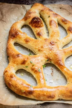 a pretzel shaped like the peace sign on top of parchment paper