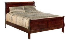 a bed that has a wooden frame and headboard with pillows on top of it