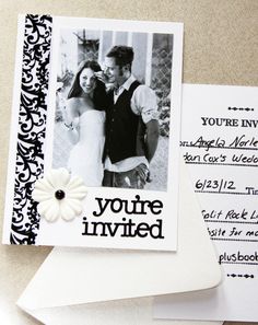 a couple is posing for a photo on their wedding day with some cards and envelopes