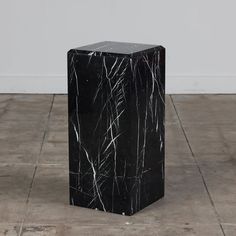 a black and white marble block sitting on top of a floor