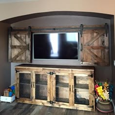 an entertainment center made out of old barn doors