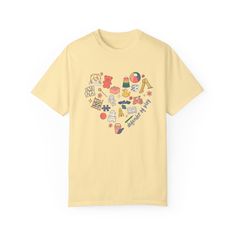 a yellow t - shirt with an image of various items in the shape of a heart