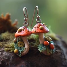 These mushroom earrings are a must-have for those who adore the enchanting worlds of goblincore or cottagecore fashion. Made from top-quality stainless steel, these clay earrings are both sturdy and long-lasting, capable of enduring any adventure. The stainless steel material is hypoallergenic, making them a great option for all skin types. Featuring intricate floral details and a charming toadstool design, these earrings exude a playful yet mysterious aura, making them a perfect addition to any outfit. They are ideal for those who wish to explore the mystical forest or add a touch of whimsy to their daily look. Whether you're a fairy or a gnome enthusiast, these mushroom earrings will undoubtedly become a treasured part of your jewelry collection. They also make a fantastic gift for anyon Goblincore Earrings, Mushroom Accessories, Cottagecore Jewelry, Mushroom Jewelry, Diy Earrings Polymer Clay, Mushroom Earrings, Mystical Forest, Dark Cottagecore, Cottagecore Fashion