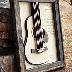 a wooden frame with a guitar cut out in it