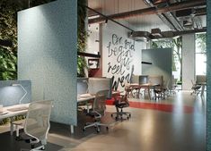 an office with plants growing on the wall and desks in front of it,