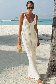 Discover effortless elegance with this White Knit Hollow Out Long Dress for women. Perfect for beach holidays or parties, this slim fit dress features a V-neck design, ruffled hem, and a backless style. Made with high-quality knitwear material, it offers comfort and style in one stunning piece. V-neck Bodycon Maxi Dress For Beach, Chic Backless Crochet Dress For Vacation, Fitted V-neck Vacation Dress, Chic Fitted Dress For Vacation, Elegant Dresses For Party Vacation, Casual Fitted Backless Beach Dress, Fitted Backless Casual Beach Dress, Fitted Beach Dress For Brunch, Fitted Sleeveless Crochet Dress For Vacation