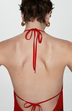 the back of a woman wearing a red halter top