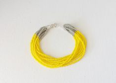 "Yellow and silver bracelet. You receive ONE bracelet. You can choose from 7 different sizes at checkout. ❤ SIZES This item comes in several sizes, kindly choose at checkout. The easiest way to find out which length suits you best is to measure a bracelet you already own, from one end to the next, including clasp. You can use a ruler or any measuring device at home. The standard size for an average woman is 7\". For a child, perhaps a 6\" would be appropriate. If you'd like a clasp extender beca Yellow Bracelet Beads, Bracelets Seed Beads, Yellow Beaded Bracelet, Multistrand Bracelet, Beaded Jewelry Bracelets, Yellow Bracelet, Bracelets Boho, Seed Bead Bracelet, Multi Strand Bracelet