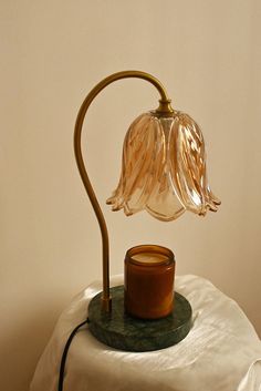 a table lamp sitting on top of a white cloth