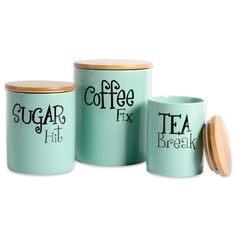 three tea canisters with lids and wooden lids, one has the word coffee fix on