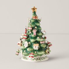 a ceramic christmas tree with ornaments on it