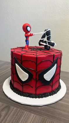 a spider - man cake is decorated with fondant and sprinkled icing