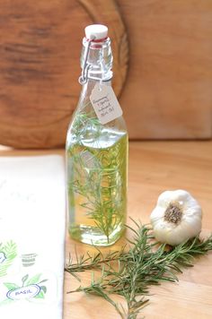 a bottle of rosemary oil next to an onion