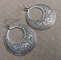 "These are fabulous and chic boho floral hoop earrings!  Make a statement without saying a word with these versatile earrings.  Perfect for everyday wear, dress them up or down! The hoops measure 1 5/8\" long by 1 1/2\" wide.  They hang from simple silver ear wire hooks.  Overall drop length is just under 1 3/4\".  Made from plated silver. I have this same earring style also available in gold. Here is a direct link to those... https://www.etsy.com/listing/1524279410/ Thanks so much for stopping Silver Boho Earrings, Big Silver Earrings, Big Dangle Earrings, Bohemian Flower, Boho Hoop Earrings, Statement Hoop Earrings, Earrings Big, Floral Hoops, Statement Drop Earrings