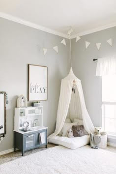 a child's bedroom with a white canopy bed