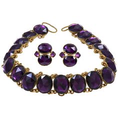 Amazing "Queen Anne" amethyst paste necklace set in gilt metal. Please Note: The earrings are not included. This style of jewelry was misnamed for Queen Anne, who reigned from 1695 to 1714, as the necklace was made in the mid 18th century. The necklace is comprised of non-graduated rivieres. The vivid purple paste stones used are faceted as rose cuts and collet-set. The necklace fastens with a ribbon. The paste stones run 10.5 inches while the ribbon makes up the rest of the length of the neckla 18th Century Jewelry, Riviere Necklace, Vintage Choker Necklace, Georgian Jewelry, Mesh Necklace, Ribbon Jewelry, Vintage Choker, Necklace And Earrings Set, Antique Necklace