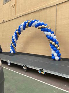 an arch made out of balloons on the back of a truck