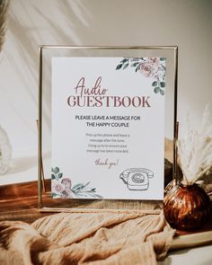 the wedding guest book is sitting on a table