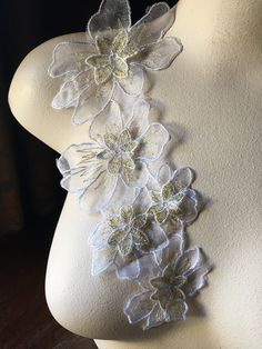 the back of a mannequin with flowers on it