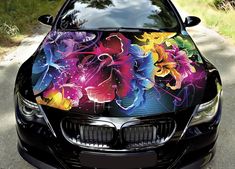 a car with colorful flowers painted on it's hood