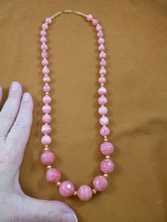 25 inch long faceted round Pink Rhodochrosite gemstone graduated beaded  with gold tone spacers Neck Luxury Necklace With Faceted Round Beads, Luxury Temple Jewelry Beaded Necklace With Round Beads, Luxury Temple Necklace With Polished Round Beads, Luxury Faceted Round Bead Crystal Necklaces, Pink Faceted Round Bead Necklaces, Faceted Pink Beaded Necklaces, Pink Faceted Round Beaded Necklaces, Pink Round Beaded Necklaces With Faceted Beads, Pink Round Beaded Necklace With Faceted Beads