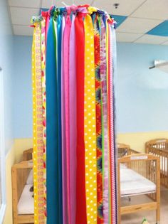 colorful ribbons are hanging from the ceiling in a child's room