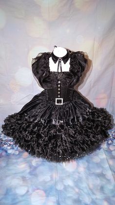 Luxury Wednesday Addams inspired tutu dress. Collar included. Dip hemmed skirt so knee length in the front going to floor length at the back. The top consists of a glitter material panel which is decorated. All of my tutus are made to order and consist of four layers of polyester tulle which makes it lovely and full. I use a combination of plain tulle and sequin tulle which gives the added wow factor.  My tutus are made on unlined crochet tops and glitter panels are added to the front. The tops are also felt backed to ensure the design does not cause any irritation to your little one. This tutu is designed at ankle length so if you could provide me with the measurement from waistline to ankle, I can make the dress accordingly. Made to order only. Sponge clean only, cannot machine wash. Bei Fitted Corset Dress With Cancan For Costume Party, Halloween Costume Party Fitted Corset Dress, Fitted Corset Dress For Halloween Cosplay, Fitted Corset Dress For Halloween Costume, Halloween Party Petticoat With Ruffles, Halloween Ruffled Petticoat For Party, Punk Style Corset Dress For Halloween Party, Halloween Fancy Dress Corset Dress, Halloween Costume Petticoat With Attached Cancan