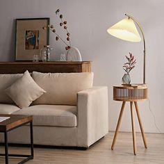 a living room with a couch, table and lamp