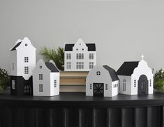 small white houses are sitting on a black table