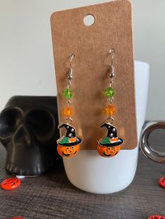 Adorable handmade Jack o Lantern charm drop earrings made with crystal beads. Perfect for Halloween!  * All materials were cleaned and sanitized prior to use and kept in a clean smoke free environment. Comes packaged in a mesh drawstring bag. Dangle Earrings As Halloween Gift, Dangle Earrings For Halloween Gift, Halloween Gift Beaded Dangle Earrings, Halloween Beaded Dangle Earrings Gift, Green Earrings For Halloween Gift, Hypoallergenic Jewelry For Halloween Gift, Hypoallergenic Jewelry Gift For Halloween, Halloween Dangle Jewelry Gift, Handmade Green Halloween Earrings