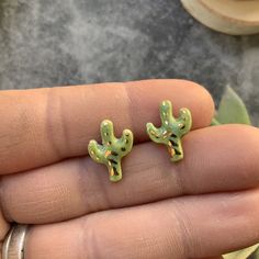 These tiny green and gold cactus studs are adorable! They are made of porcelain and perfect for a unique touch on your ears!  Earrings are glued onto stainless steel, hypoallergenic posts and include backs. Each pair will come in a jewelry gift box, ready for gifting! Southwest Boho, Cactus Earrings, Green Cactus, Earrings Stud, Jewelry Gift Box, Boho Earrings, Earrings Gold, Jewelry Earrings Studs, Green And Gold