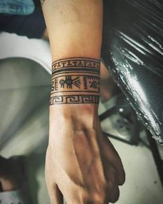 a person's arm with a tattoo on the wrist and an arrow in the middle