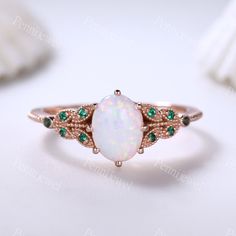 Vintage White Opal Engagement Ring,Opal Emerald Promise Ring,Rose Gold,6x8mm Oval Cut Opal Anniversary Ring,October's Birthstone,Gift For Her Main Ring Metal Type: 10k/14k/18k solid rose/white/yellow gold Center Stone: 6x8mm Oval Cut Lab-created White Opal Engagement Ring Side Stone: Lab-created Emerald Wedding Band Prongs pave set This ring can be matched with other wedding band. See the matching band please visit: www.etsy.com/shop/PENNIjewel?ref=listing-shop2-all-items-count%C2%A7ion_id&secti Opal And Pearl Engagement Ring, Emerald Opal Engagement Ring, Lotus Engagement Ring, White Opal Engagement Ring, Vintage Opal Engagement Ring, Emerald Wedding Band, Blue Topaz Engagement Ring, Gold Topaz, Fire Opal Ring