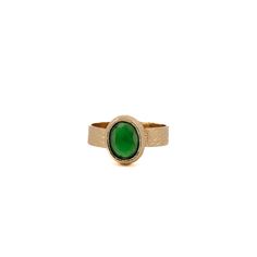 Cleopatra Gold And Green Jade Stone Adjustable Ring is a regal and captivating piece that effortlessly blends ancient allure with modern sophistication. This adjustable statement ring features a 24K gold-plated band that cradles a mesmerizing green jade gemstone, creating an adjustable and opulent accessory fit for a queen. Green Jade: Revered for its rich green hues, jade is a symbol of purity, harmony, and good fortune. The vibrant green of this gemstone not only evokes a connection to nature but also carries cultural significance, making it a fitting choice for a ring inspired by the legendary Cleopatra. The adjustable design ensures a comfortable fit, allowing you to showcase this piece with ease and style.  Details 24K gold plated brass Green Jade Gemstone Adjustable size 5'' to 8'' A Elegant Brass Rings With Gemstone, Modern Emerald Cabochon Rings, Elegant Brass Rings With Cabochon, April Birthstone Jewelry, March Birthstone Jewelry, Jade Gemstone, Gold Gemstone Ring, Gold And Green, Green Hues