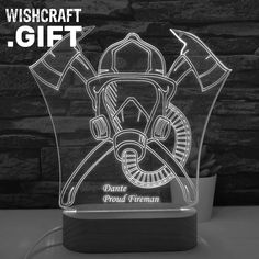 a glass trophy with a fireman's helmet and axes on it that reads wishcraft