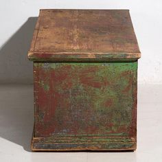 an old wooden box sitting on top of a white floor