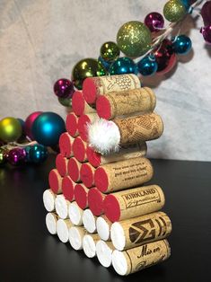 several wine corks stacked on top of each other with christmas decorations in the background