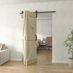 a living room with a white couch and wooden doors open to reveal a dining area