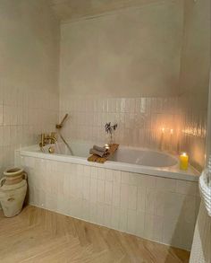 a bathroom with a tub and candles in it