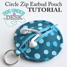 a blue and white polka dot coin purse with earbuds in it's pouch