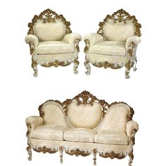 two white couches with gold trimmings and ornate carvings on the armrests