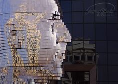 the reflection of a building in its glass facade