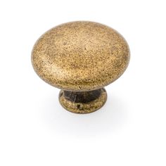 an antique brass knob on a white background