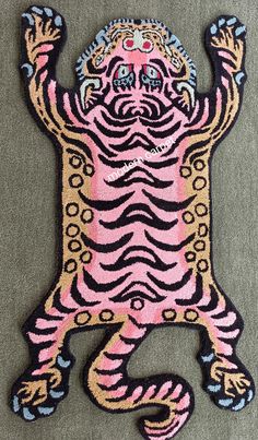 a pink and black rug with a tiger on it's back, arms in the air