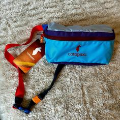 Cotopaxi Bataan 3l Hip Pack - Del Da Shades Of Blue + Purple + Pink Bag Orange And Teal Strap Maroon Zipper Brand New With Tags! Blue Bag With Water Bottle Pocket For Outdoor Activities, Multicolor Casual Hiking Bag, Casual Multicolor Hiking Bags, Sporty Blue Hiking Bags, Multicolor Nylon Hiking Bag, Bataan, Hip Pack, Orange Bag, Pink Brand