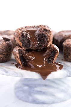 three chocolate cookies stacked on top of each other and drizzled with melted chocolate