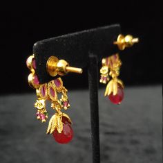 "These Earrings set has an excellent finish and gives out an exquisite sense of style. If you are looking for an amazing Fashion Jewelry set for special occasions such as Anniversary, Engagement, Party, Wedding, or for gifting, then your search ends here. Handmade Indian Temple Jewelry, best to wear it for traditional ceremonies or Indian wedding. This bridal jewelry has an ethnic finish. It has Cubic Zircon stones with semi-precious ruby and emeralds. It is a Bollywood style one gram jewelry. T Formal Jewelry Sets With Matching Earrings For Festivals, Formal Jewelry Sets With Matching Earrings, Festive Yellow Gold Jewelry Sets With Matching Earrings, Gold Temple Jewelry Bridal Earrings For Party, Gold Temple Bridal Earrings For Party, Gold Ruby Temple Jewelry Earrings, Gold-plated Jhumkas For Party, Gold Ruby Earrings For Diwali, Gold Ruby Earrings For Celebration